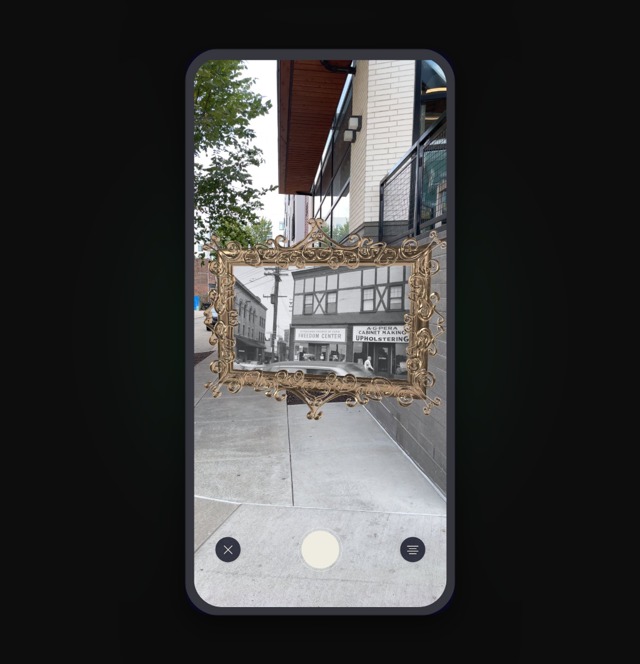 Looking Glass AR view: a gold frame holds a historic photo of the site over the present-day street.